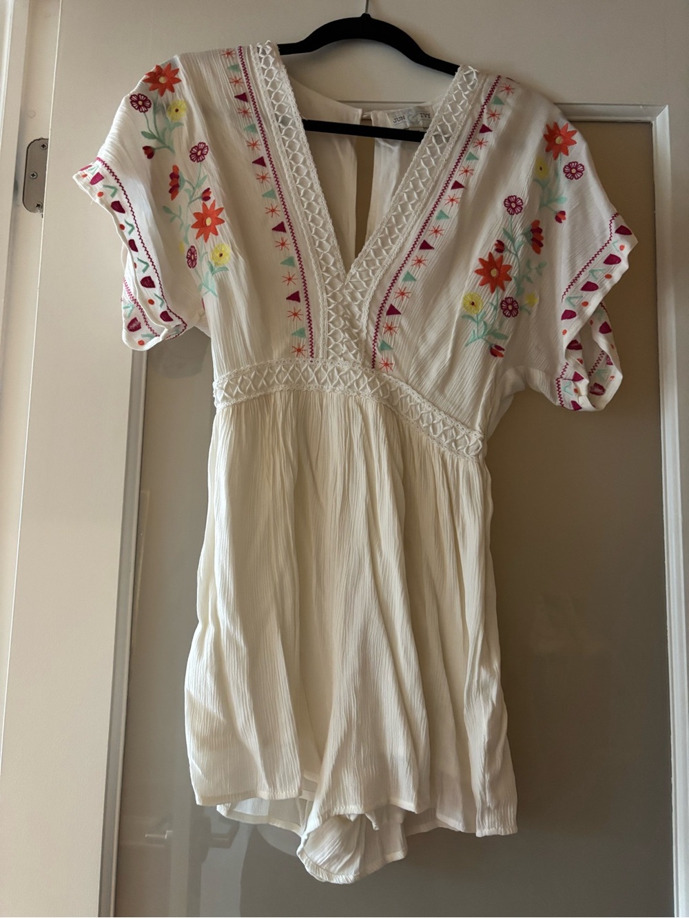 Embroidered Cream V-Neck romper with Floral Accents